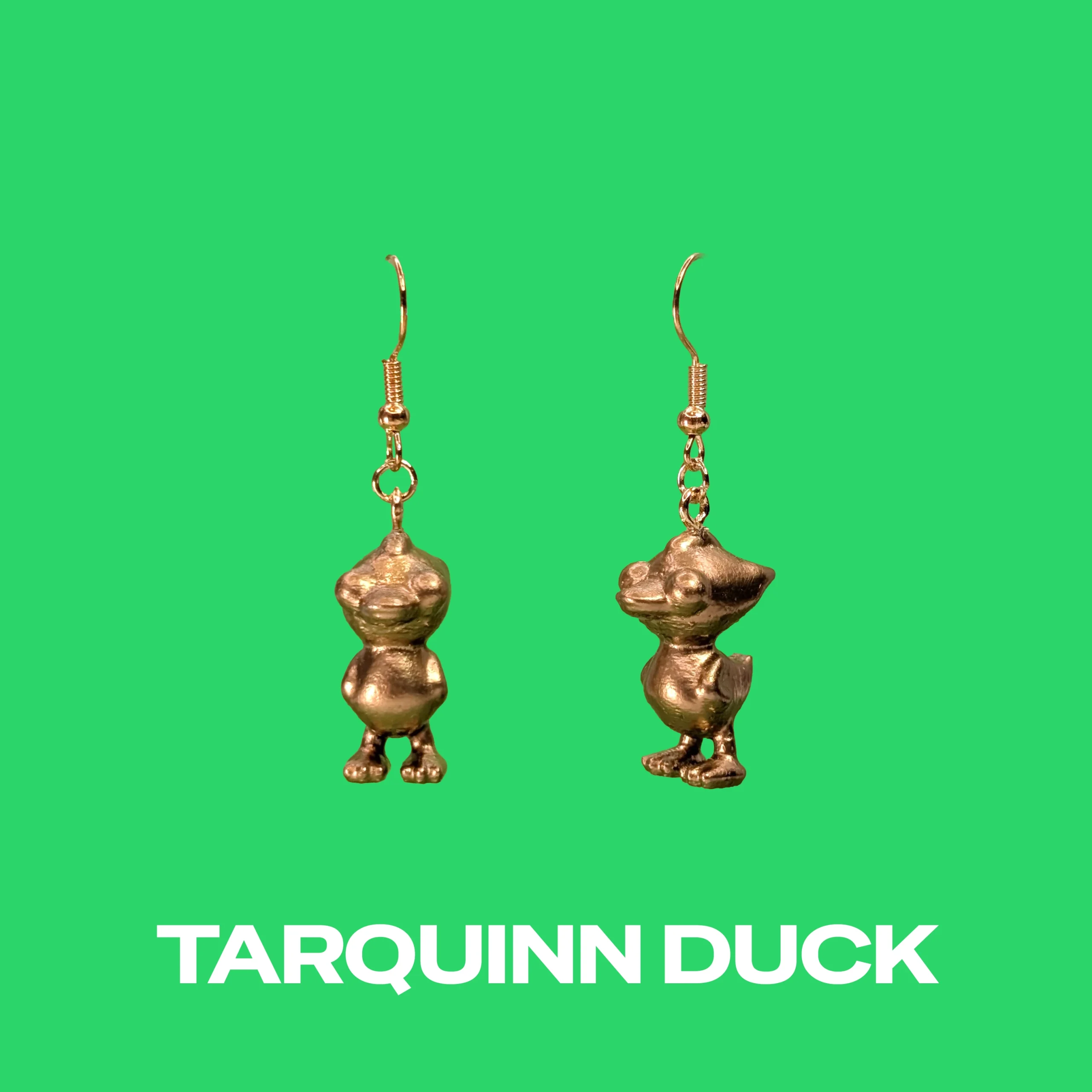 Tarquinn Duck gold earrings on a green background