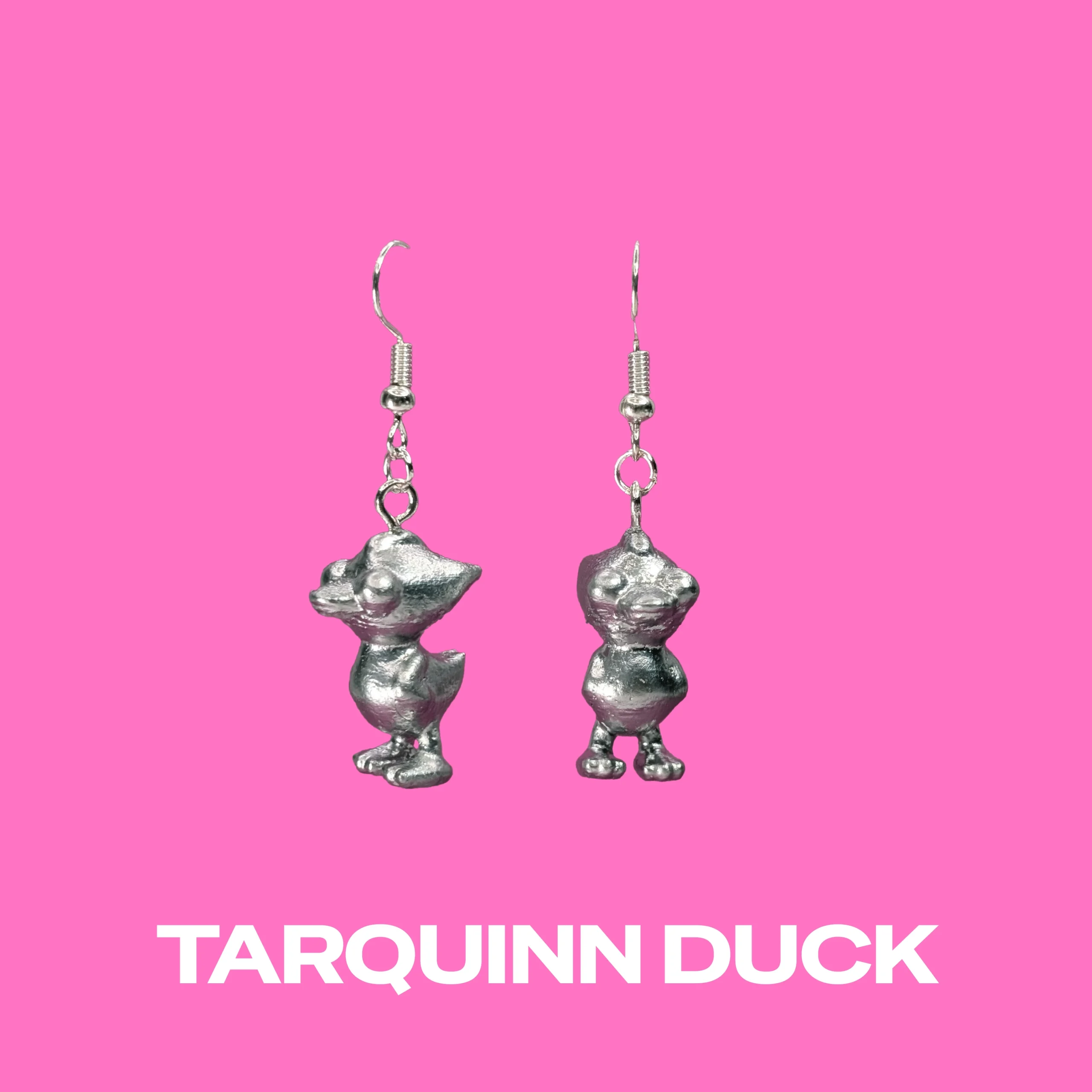 Tarquinn Duck silver earrings on a pink background