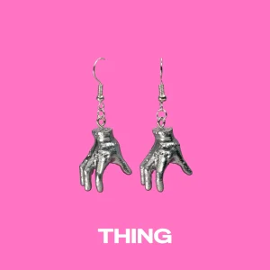 Thing silver earrings on a pink background