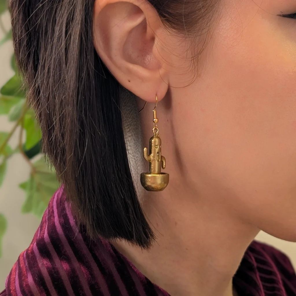 Cactuar Gold earrings worn on a model