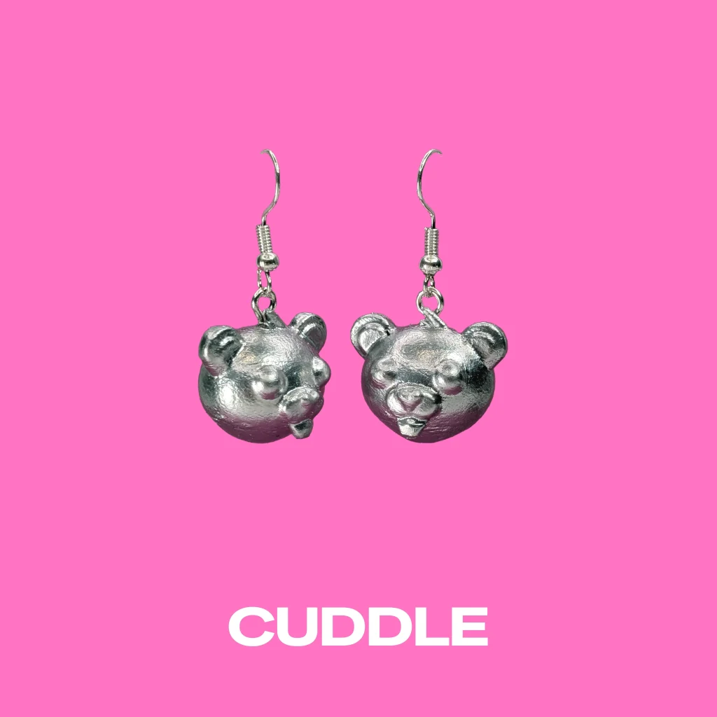 Cuddle silver earrings on a pink background